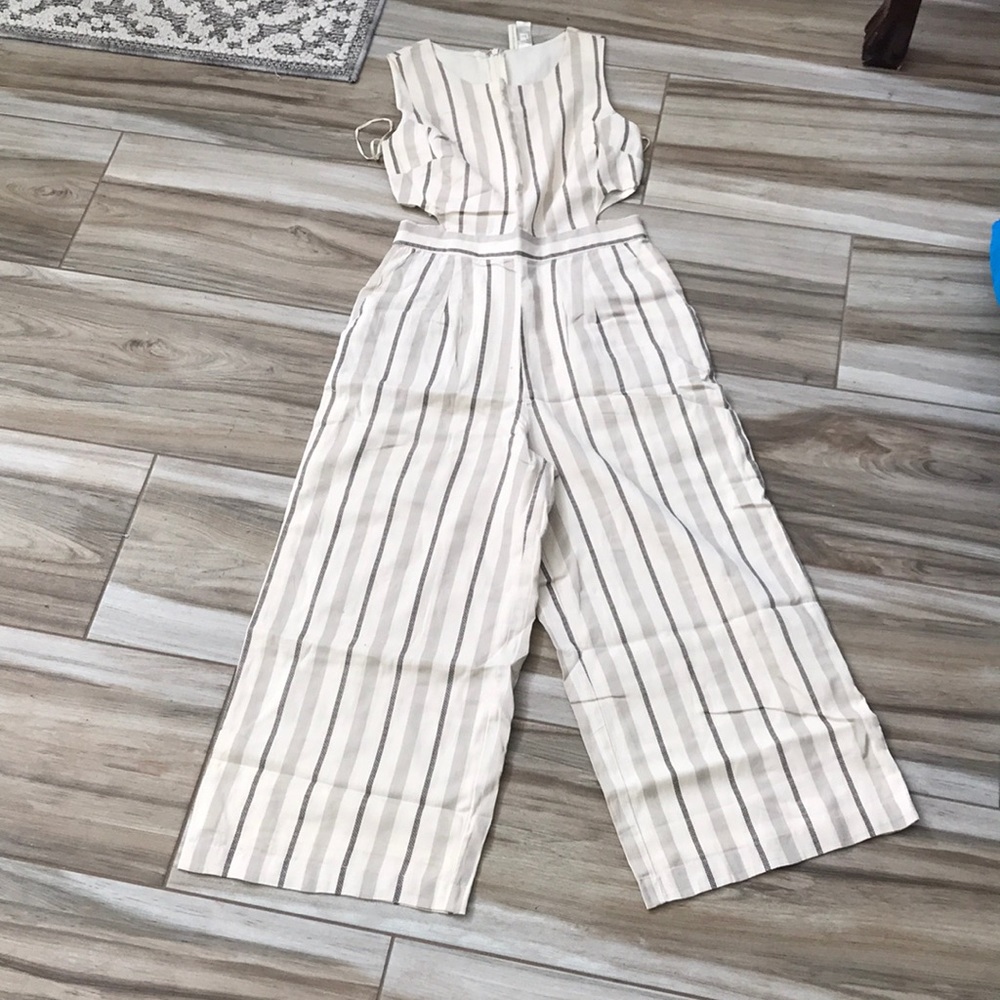 Cream/black jumpsuit with size waist openings. Has back zipper. Wide leg. NWT